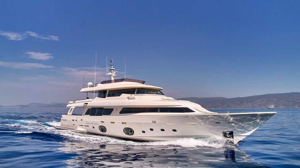 DALOLI luxury motor yacht cruising in calm waters under a clear blue sky in Greece.
