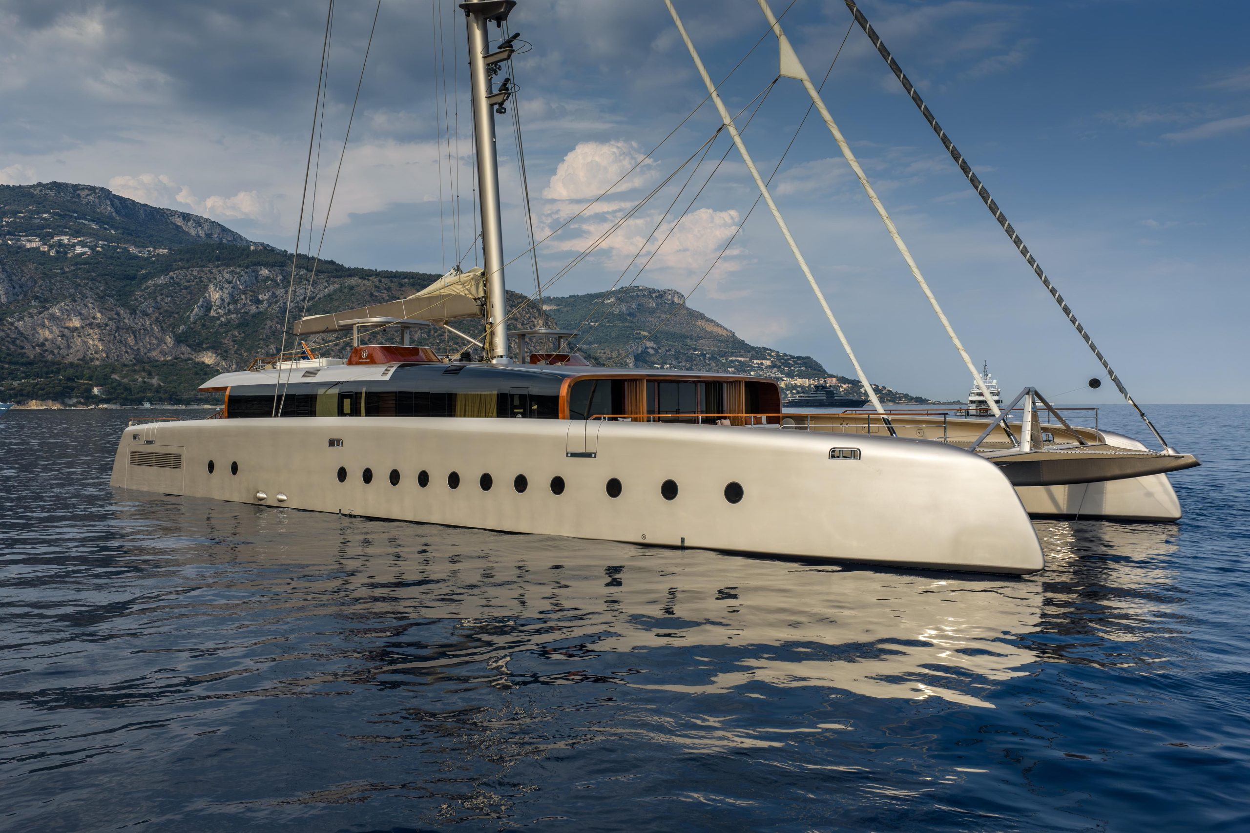 Luxury sailing catamaran ARTEXPLORER anchored in the Mediterranean, showcasing sleek modern design and expansive deck space
