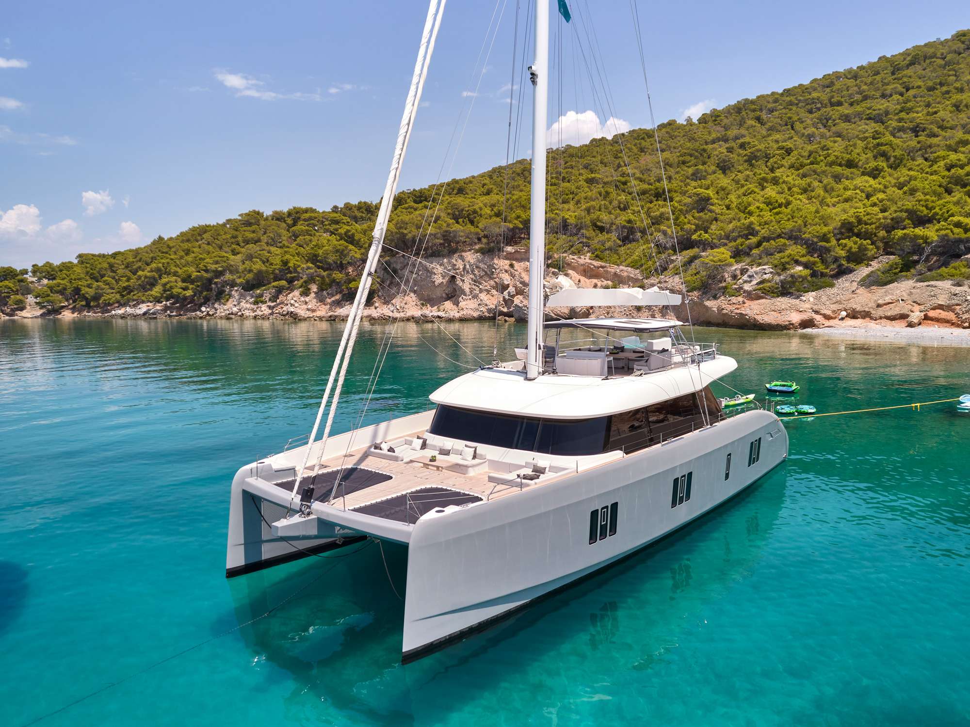 ABOVE & BEYOND luxury Sunreef 80 catamaran anchored in crystal-clear waters in Greece
