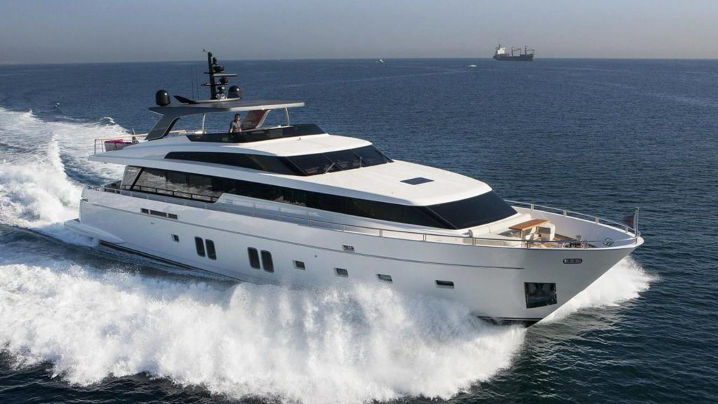 GOLDEN yacht cruising at high speed across open sea, showcasing sleek Italian design.