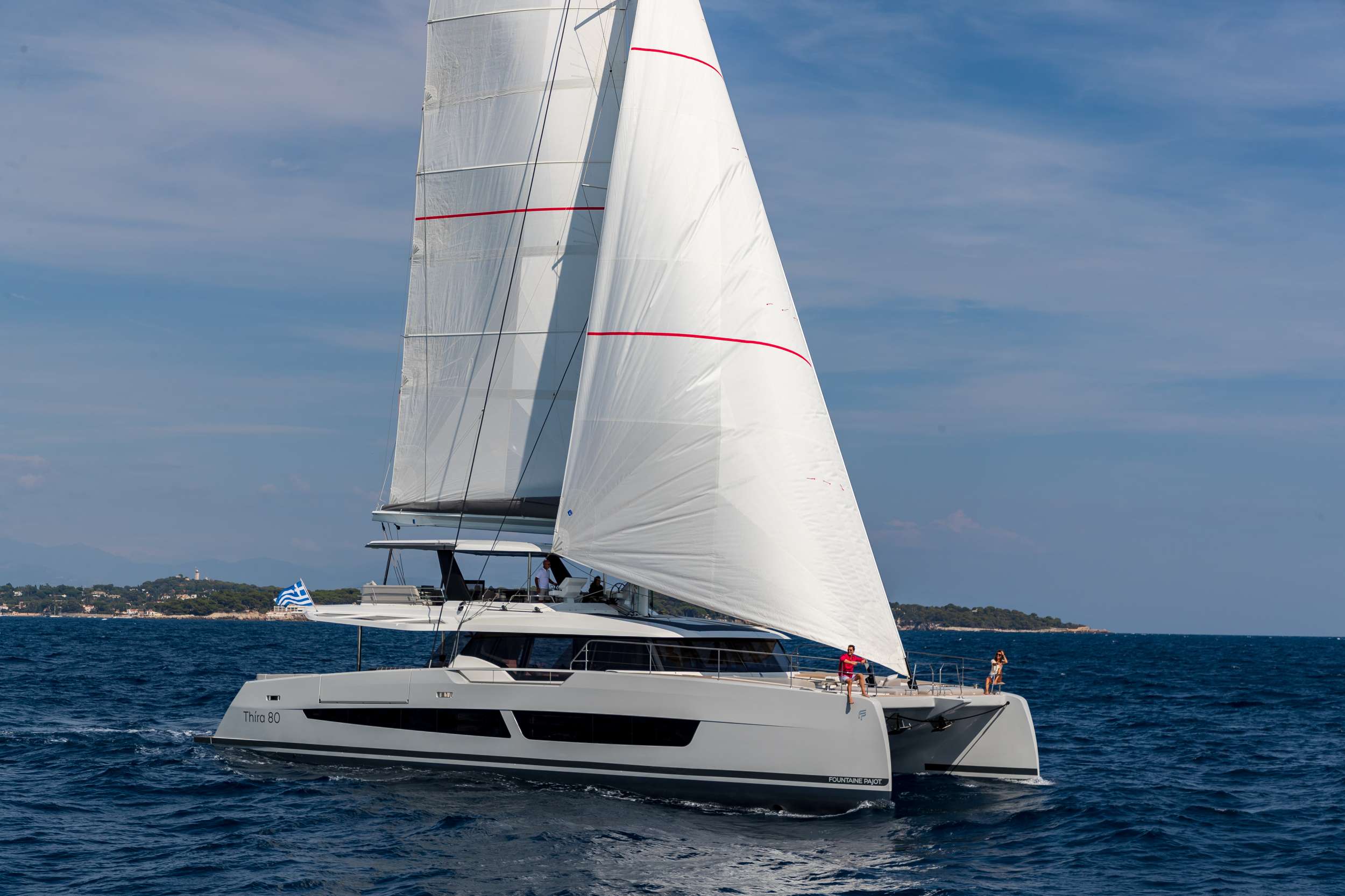 SERENISSIMA III luxury catamaran sailing in Greece with guests enjoying the spacious deck
